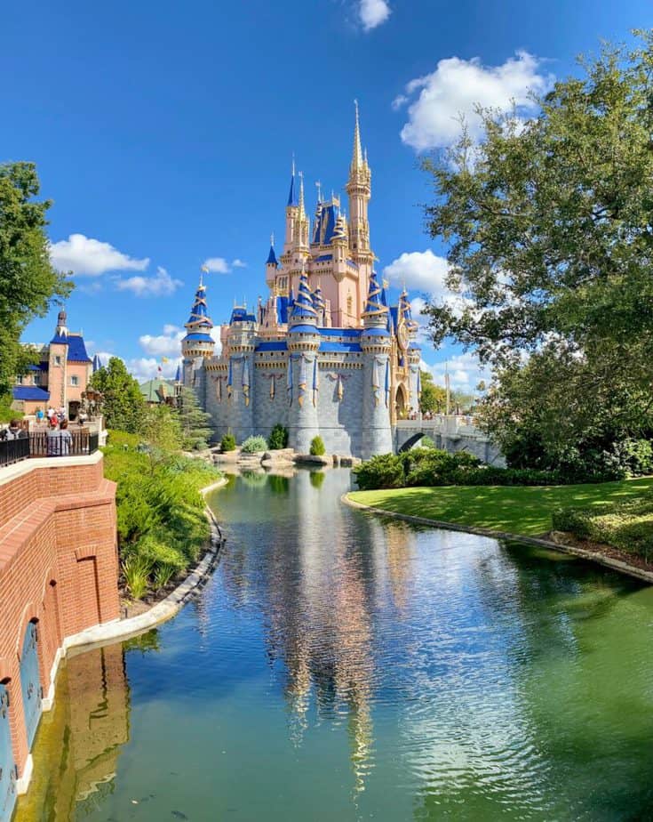 pink and blue castle at disney world. blue skies. guide to genie plus at magic kingdom