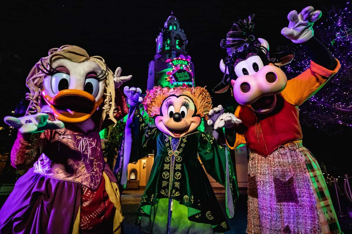 Daisy duck, Minnie mouse and Clarabelle cow dressed up for disney after dark