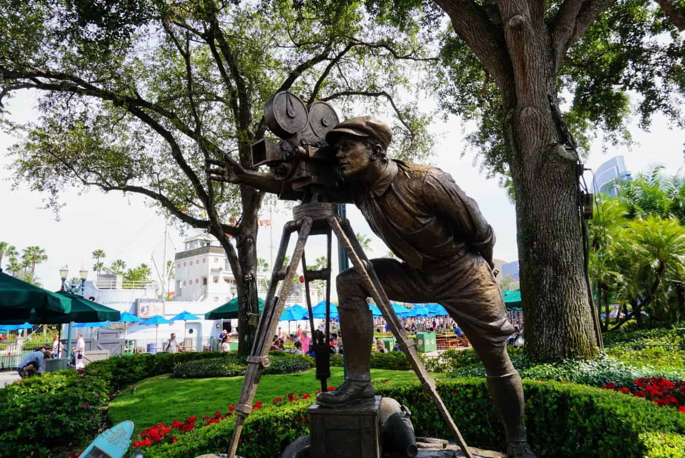 Springtime surprise yoga at hollywood studios. statue of a man looking behind the lens of a movie camera.