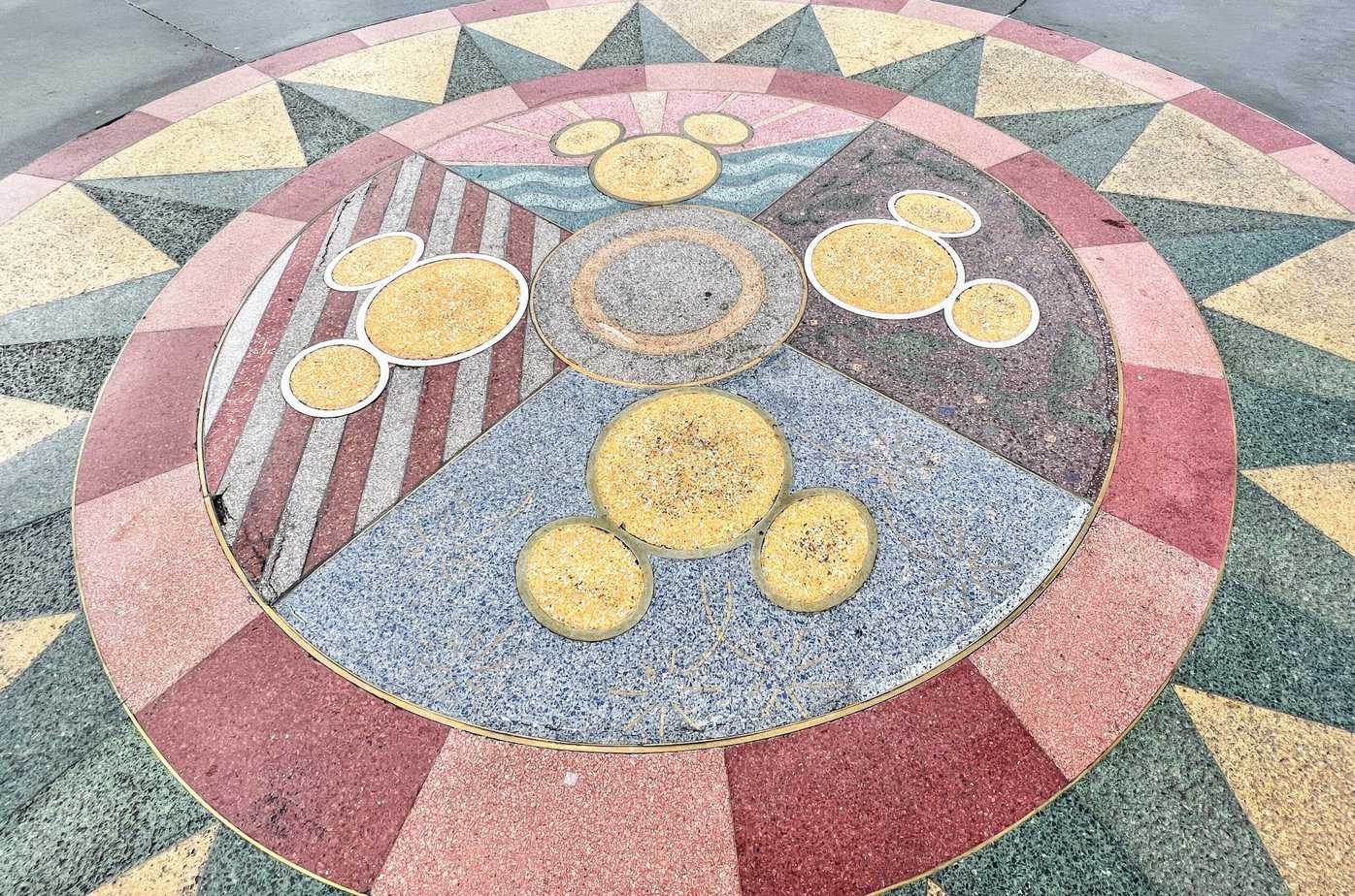 best days to visit Disneyland in March: Is Disneyland busy in March? Compass mosaic in esplanade with 4 mickey heads. 