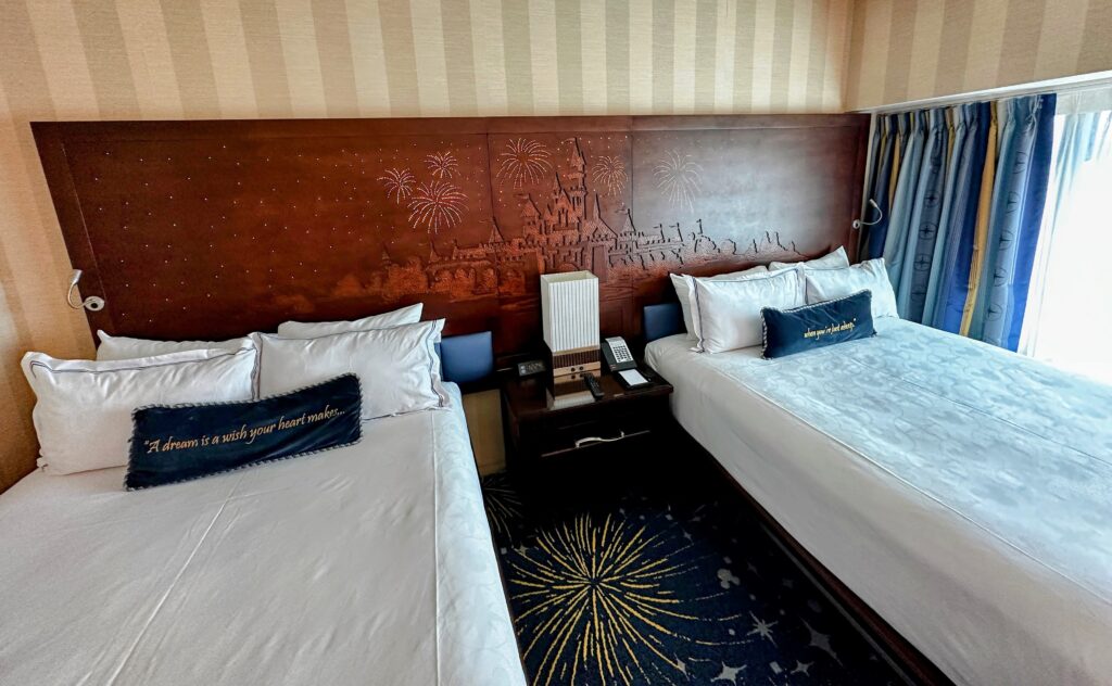 disneyland hotel room tour. two queen beds with a light up headboard at disneyland hotel. 